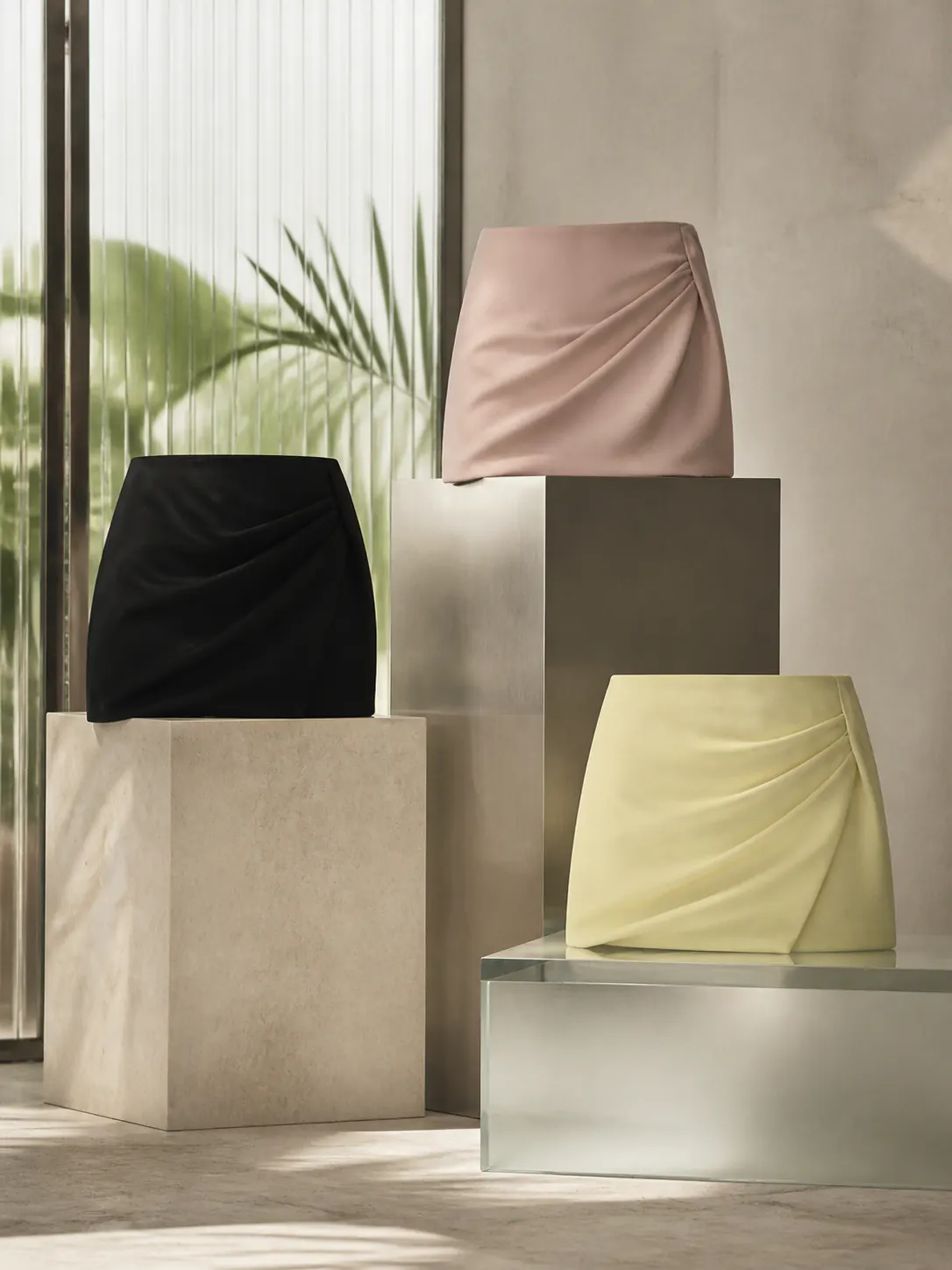 Editorial study of sculptural mini-skirt silhouettes in a warm studio